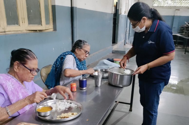 Lucy Electric India giving food to elderly